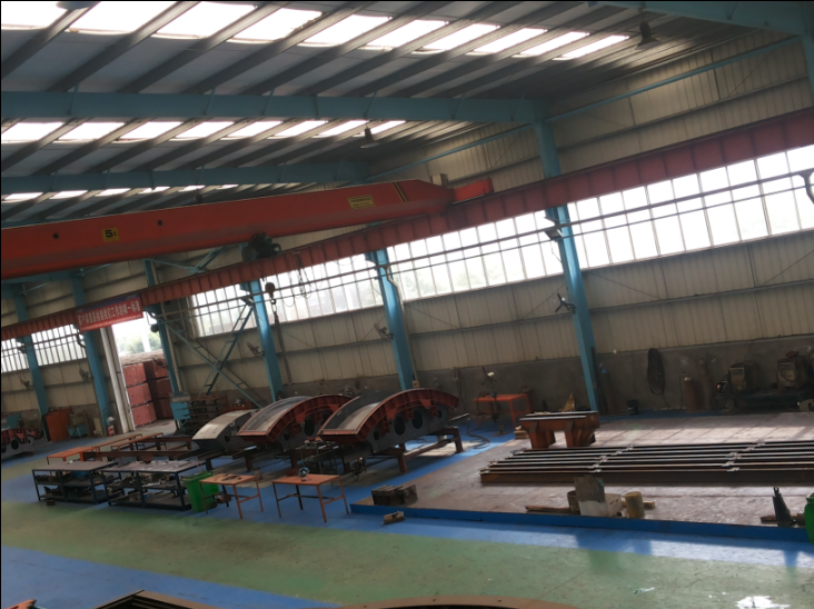Assembly bay with overhead crane and segment mould frames under construction