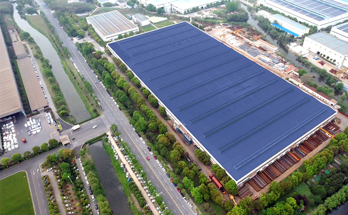 Aerial view of the Fenghe factory with a large blue-roofed production hall