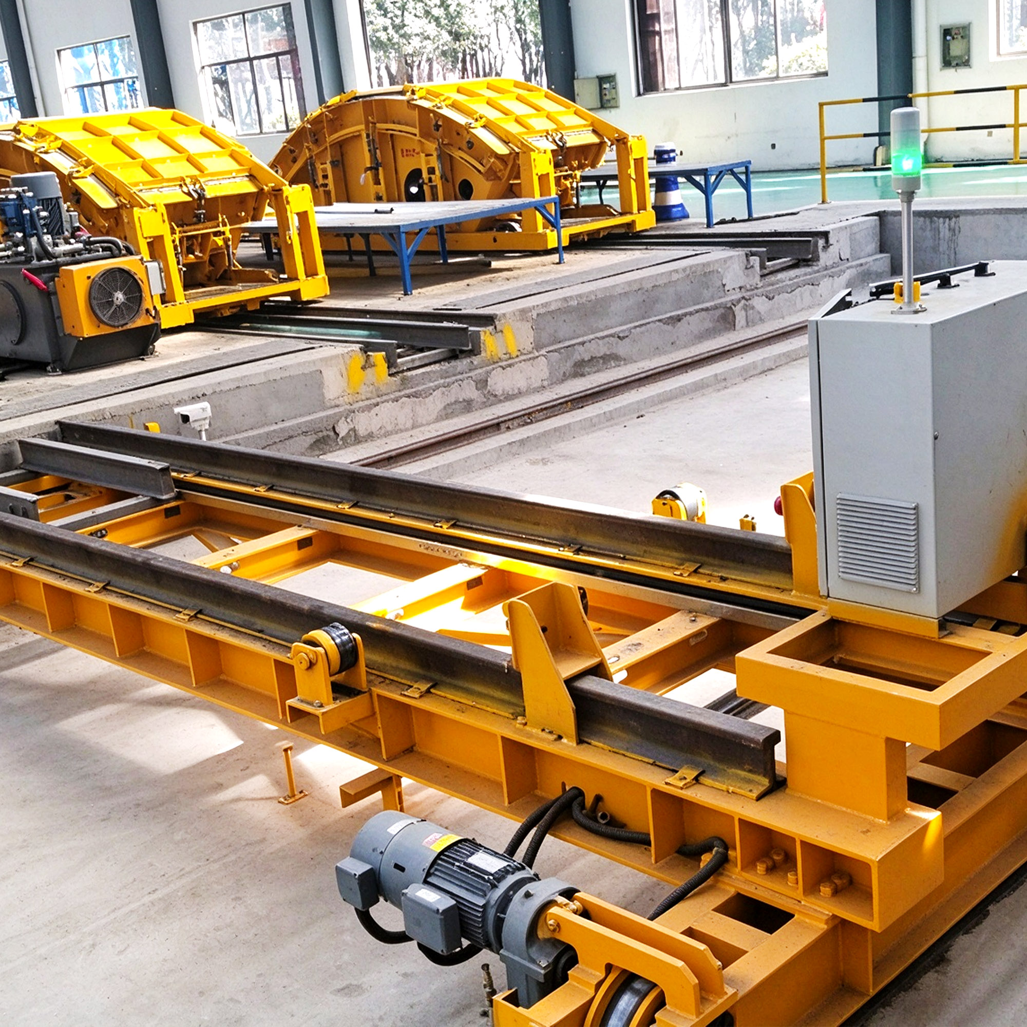Yellow ferry car on rails in front of yellow segment moulds